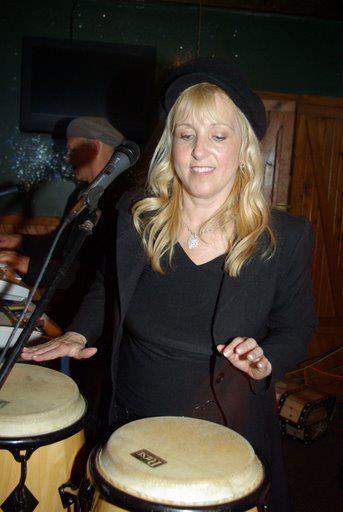 Jackie playing the congo and singing